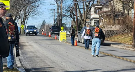 ALR Post 259 and Red Knights 44 volunteers collecting donations along a residential street