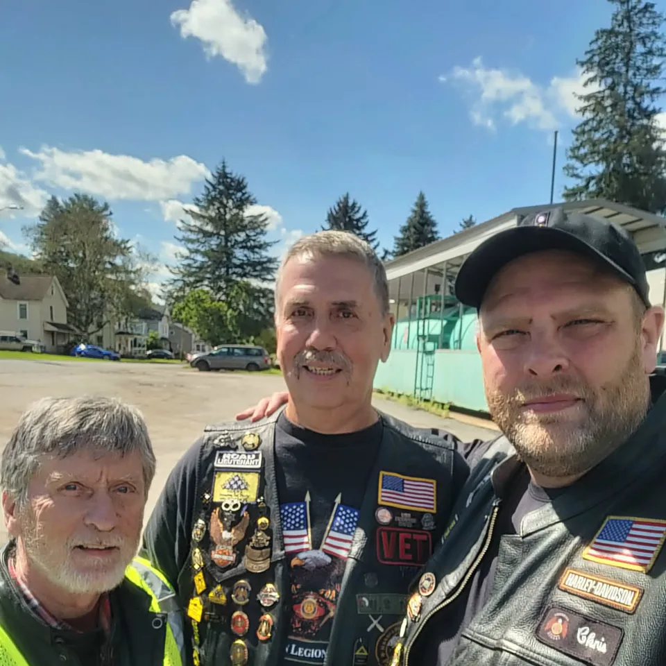 David Buck standing with two fellow Riders