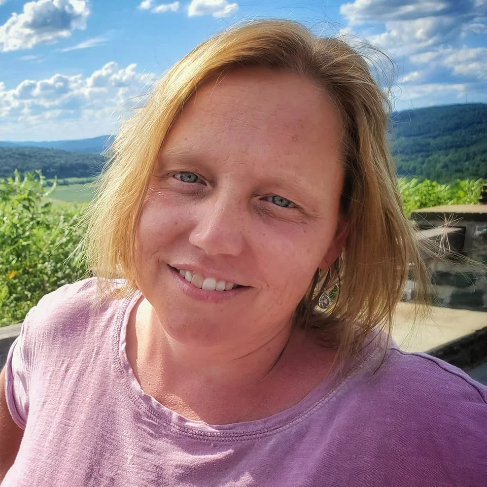 Deb Dennis smiling at a scenic overlook