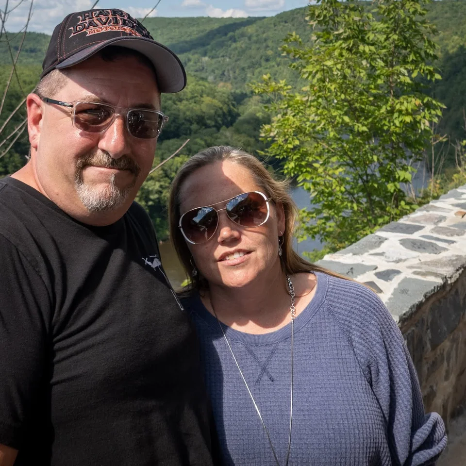 Deb and Chris Dennis standing together at a stone overlook