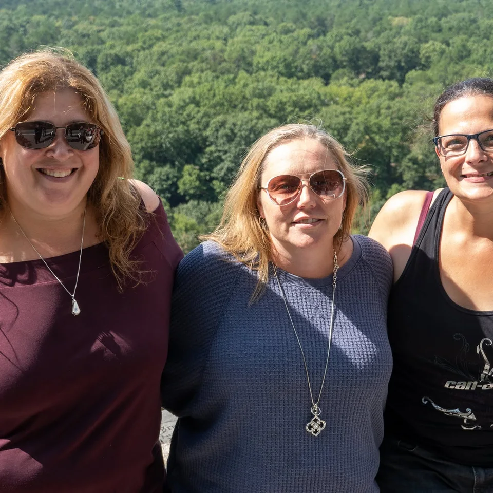Deb Dennis with two friends at a scenic overlook