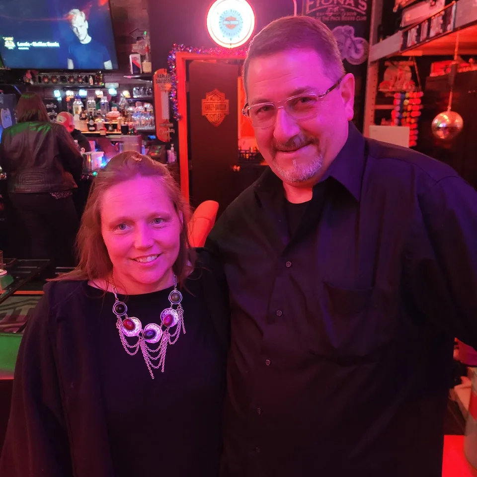 Deb and Chris Dennis standing together inside a motorcycle-themed bar