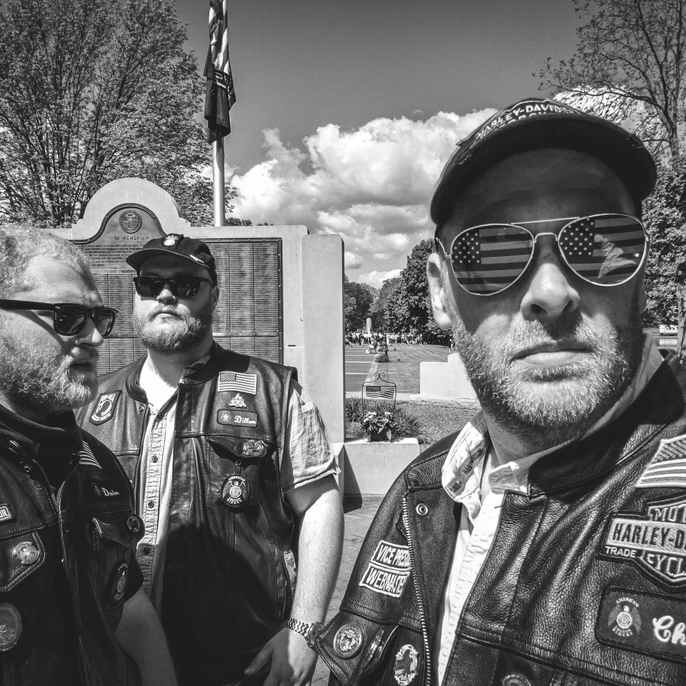 Devin Chase taking a black-and-white selfie with two fellow Riders