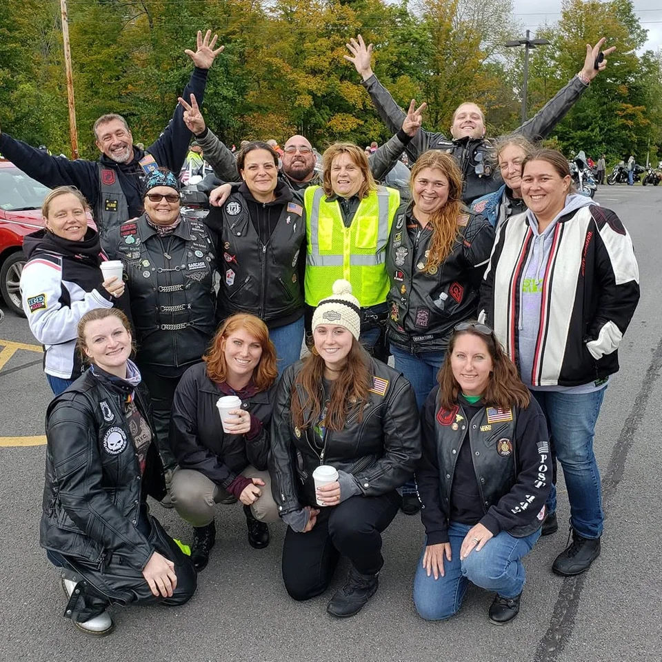 Devin Chase with a group of motorcycle riders at an outdoor event