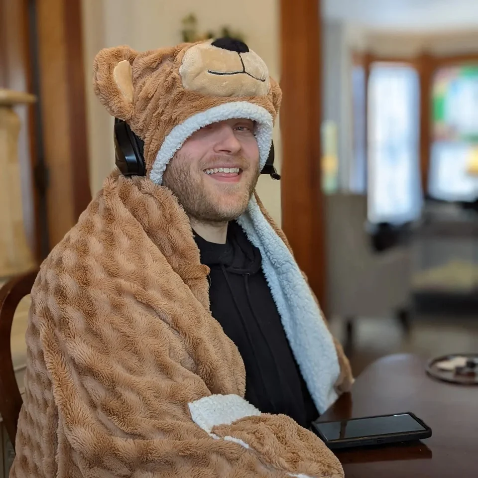 Devin Chase smiling while wearing a furry animal costume