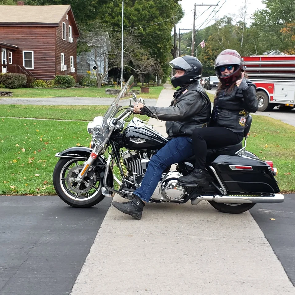 Devin Chase riding his Harley-Davidson Road King with Rebecca Chase as his passenger