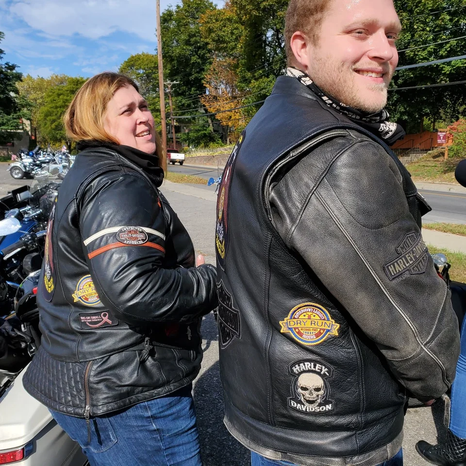 Devin Chase and another Rider showing the patches on their motorcycle jackets