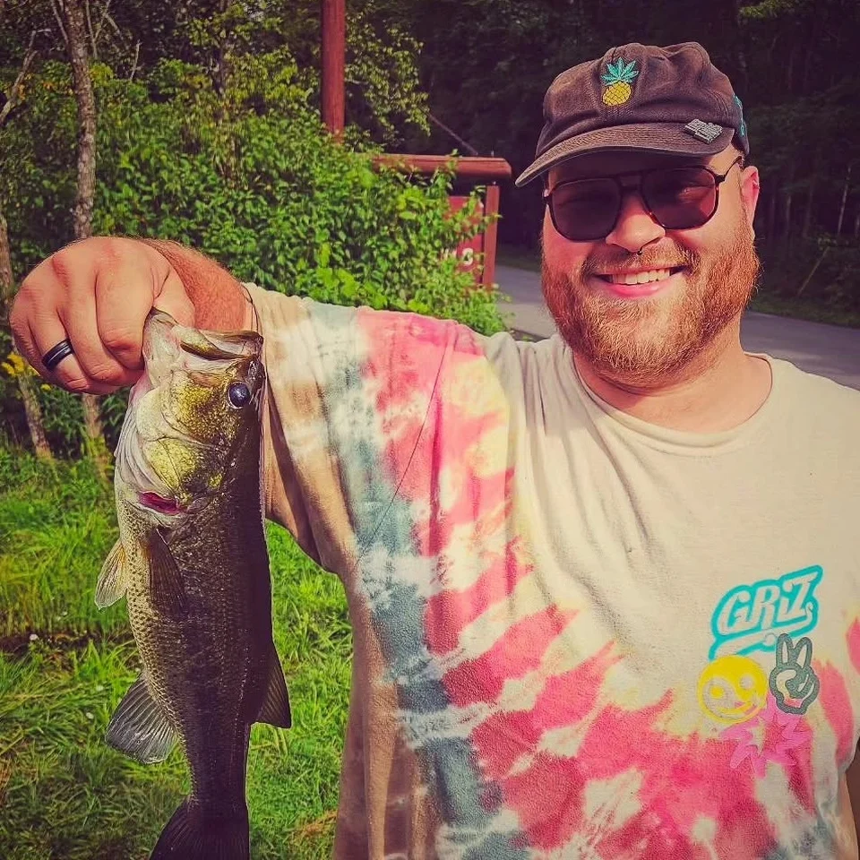 Dillon Chase holding a largemouth bass he caught