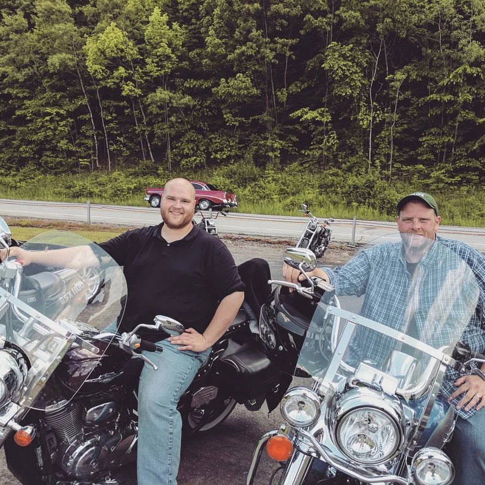 Dillon Chase and another rider standing beside their motorcycles