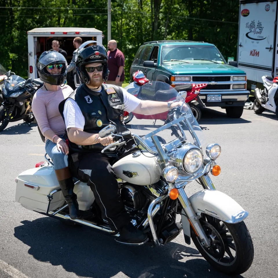Dillon Chase riding his White Gold Road King with a passenger
