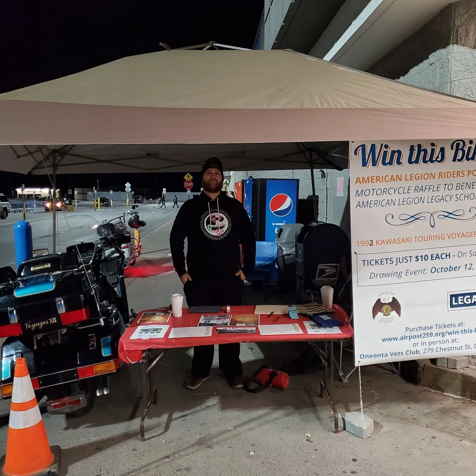 Dillon Chase staffing an American Legion Riders motorcycle raffle table