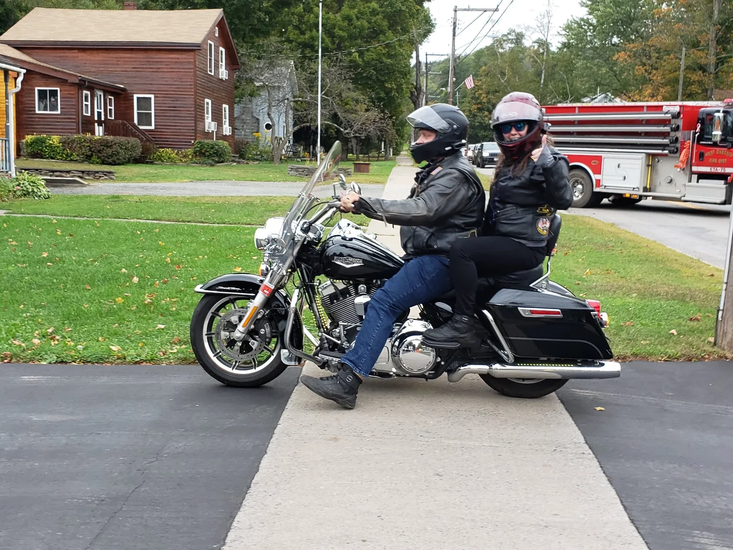 Rebecca Chase riding as a passenger on her black Harley-Davidson Road King