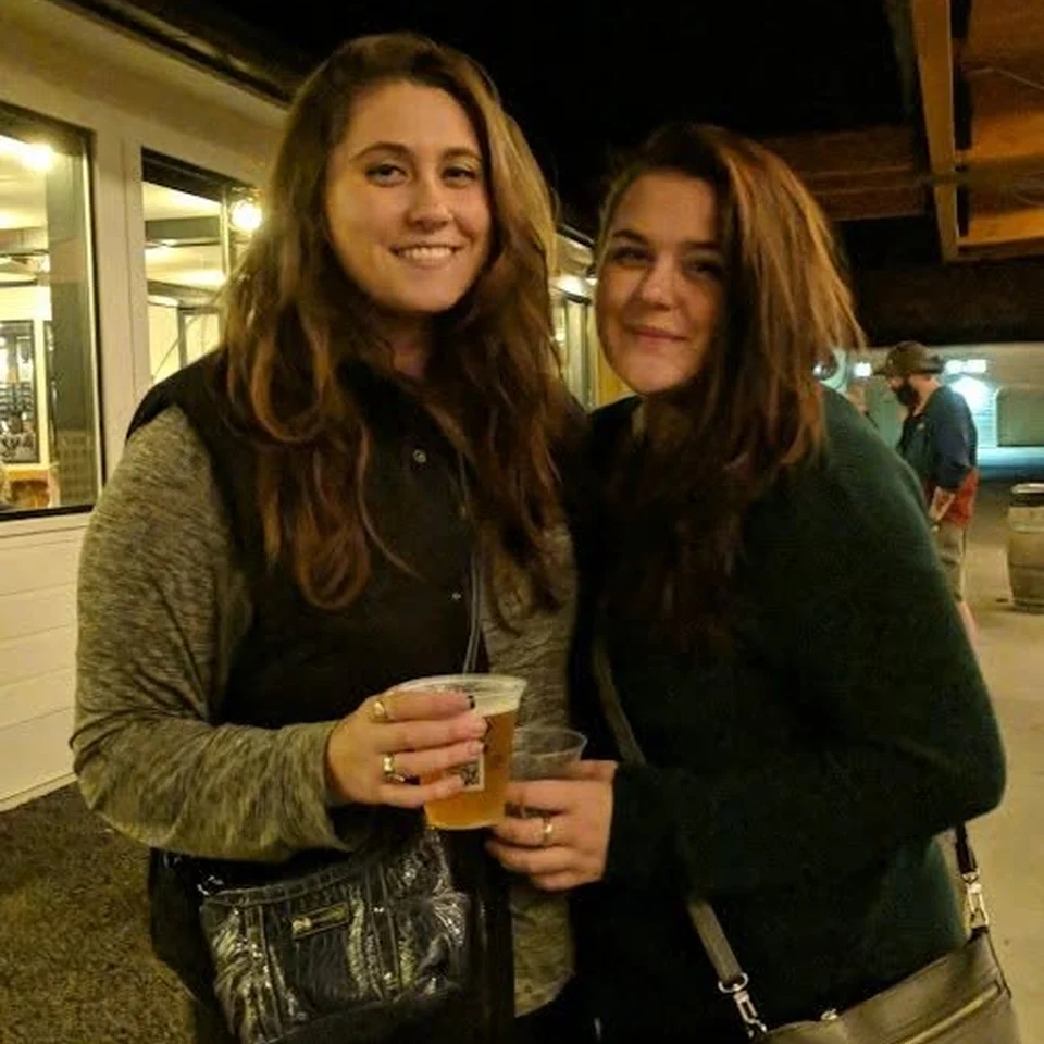 Rebecca Chase and a friend standing together at an evening gathering