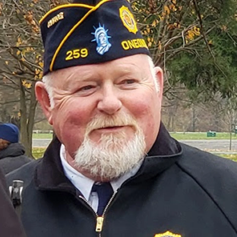 Terry Harkenreader, Commander of American Legion Post 259, in his Legion cap at an outdoor ceremony
